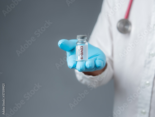 Medical doctor or laborant holding tube with virus COVID-19 vaccine,Healthcare And Medical concept.