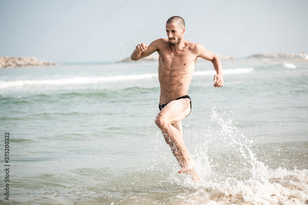 Man running training for triathlon at the beach Man running training for triathlon at the beach