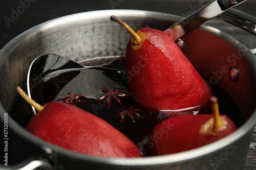 Poaching pears in mulled wine, closeup view