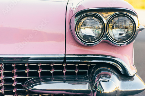 close up of antique pink and chrome car photo