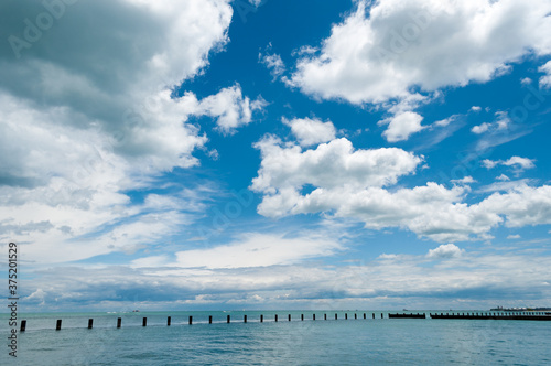 big blue skies filled with puffy clouds over Lake Michigan