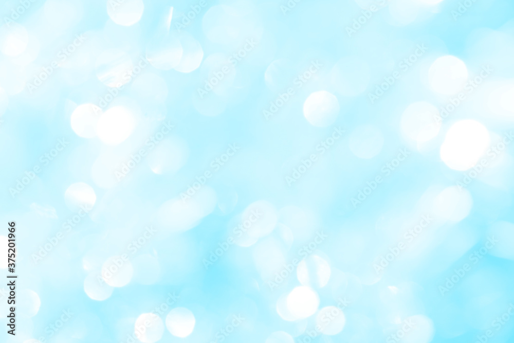 Bokeh light on blue background, sky with circle glitter light blue. Snow abstract soft glowing with vivid bright light and bokeh blur effect. 