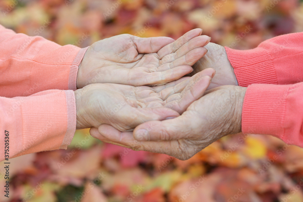 Couple holding hands together close up background Couple holding hands together close up background