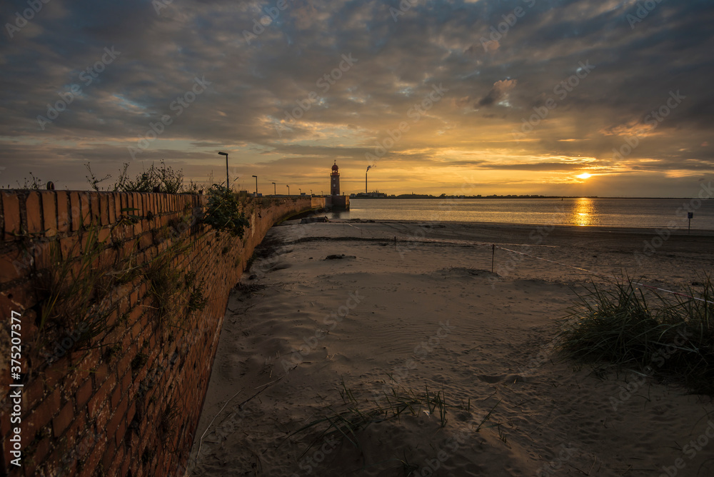 Pier and lighthouse of Bremerhaven at sunset.