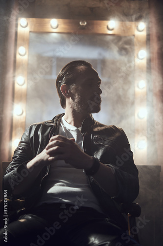 cinematic photo shoot of the confident actor celebrity look in foggy loft room