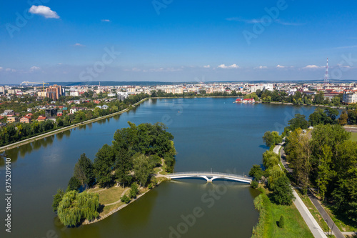 Big public lake and an island in the center of Ivano-Frankovsk city aerial view.