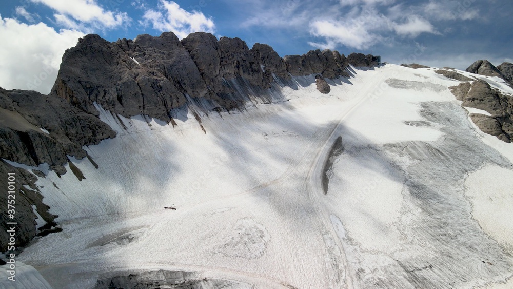 Fototapeta premium Amazing aerial view of Marmolada Glacier from drone, Dolomite Mountains, Italy