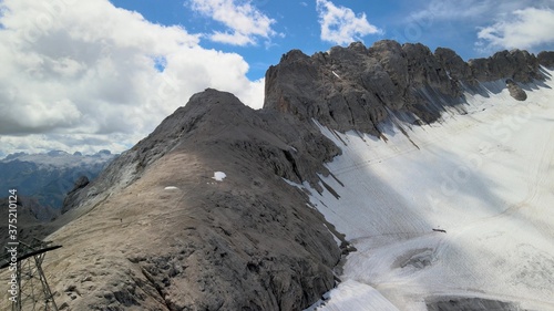 Amazing aerial view of Marmolada Glacier from drone, Dolomite Mountains, Italy