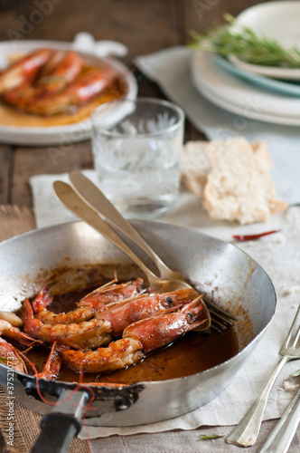 prawns in a pan with honey and rosemary