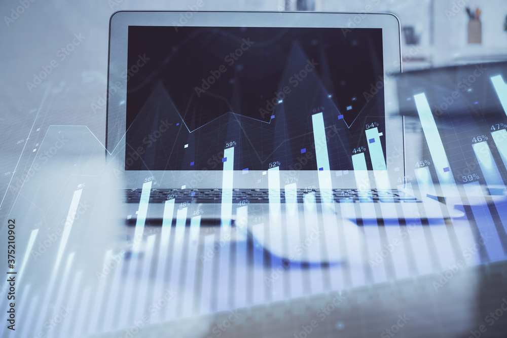 Stock market chart hologram drawn on personal computer background. Double exposure. Concept of investment. Stock market chart hologram drawn on personal computer background. Double exposure. Concept of investment.