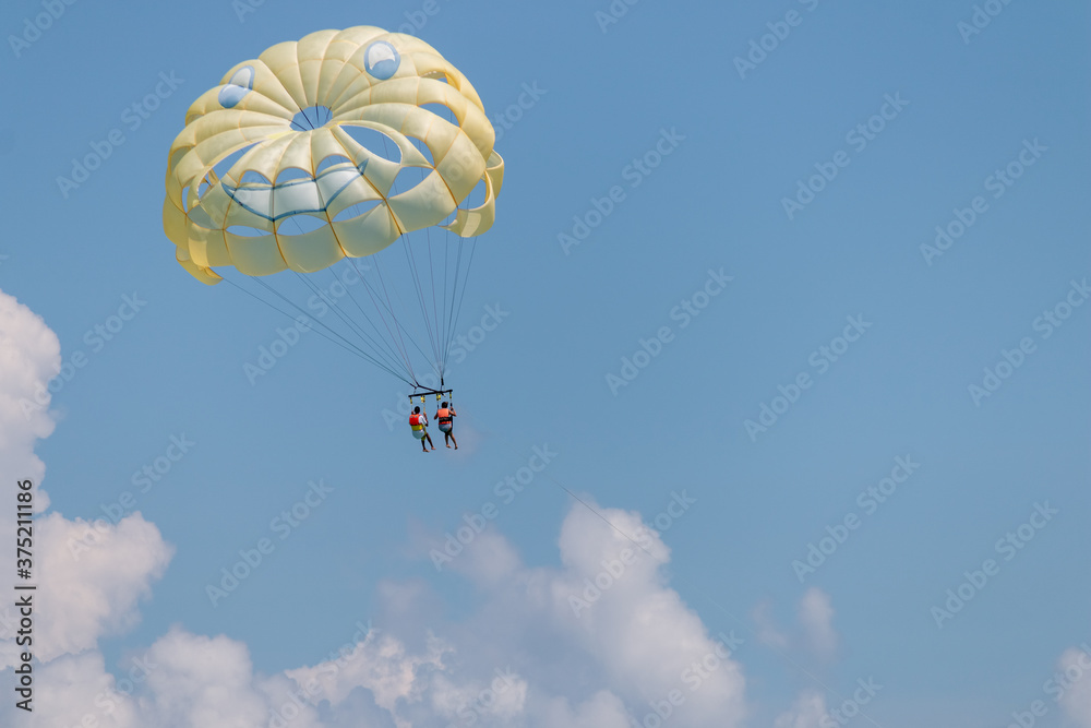 Yellow wing with happy face from skydiving pulled by a boat. Summer Yellow wing with happy face from skydiving pulled by a boat. Summer