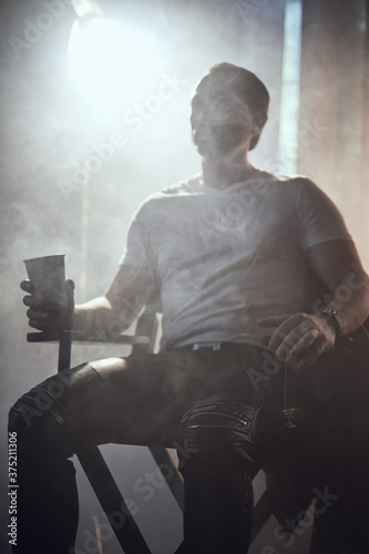 cinematic photo shoot of the confident actor celebrity look in foggy loft room