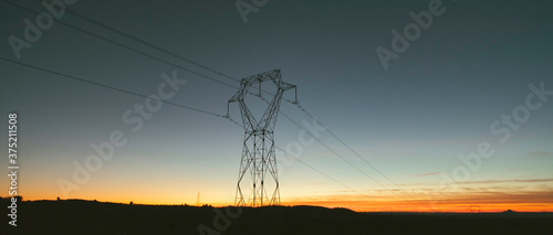 landscape with electric tower at sunset.