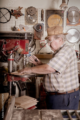 Senior Male Using Heavy Duty Drill Press photo