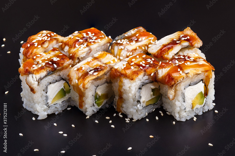 Traditional delicious fresh Unagi sushi roll set on a black background with reflection. Traditional delicious fresh Unagi sushi roll set on a black background with reflection.