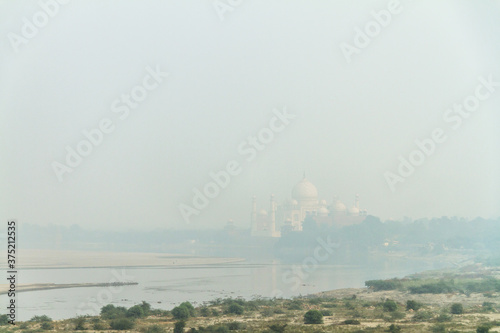 taj mahal on the river yamuna descends into smog photo