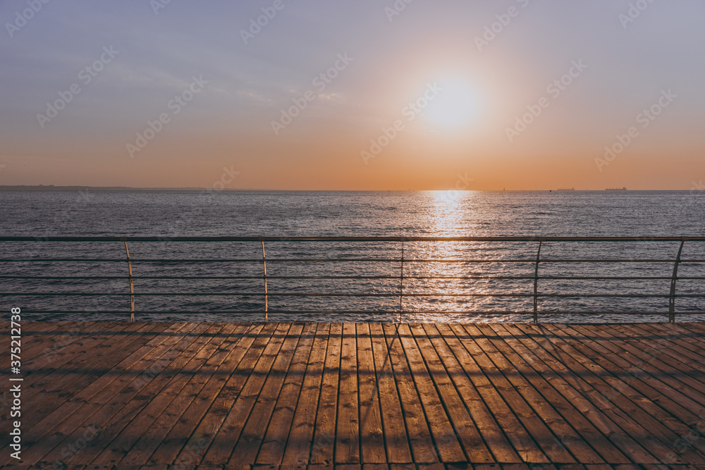 The beautiful sky background at sunrise or sunset on the waterfront sea shore in summer.