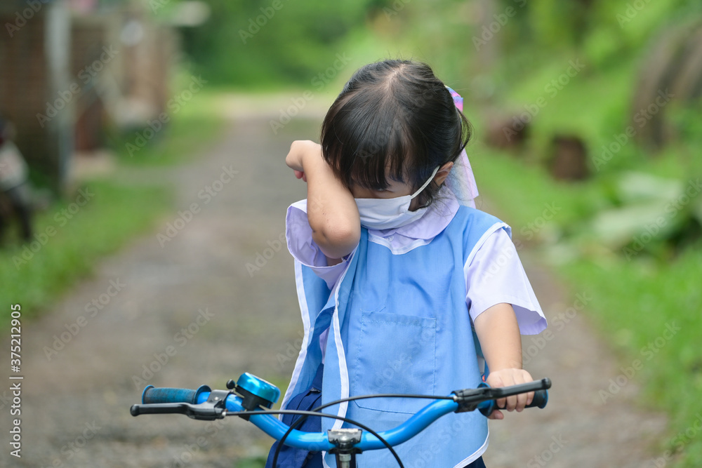 Obraz premium little girl crying while sitting on bicycle at outdoors road