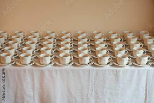 many cups and saucers arranged uniformly