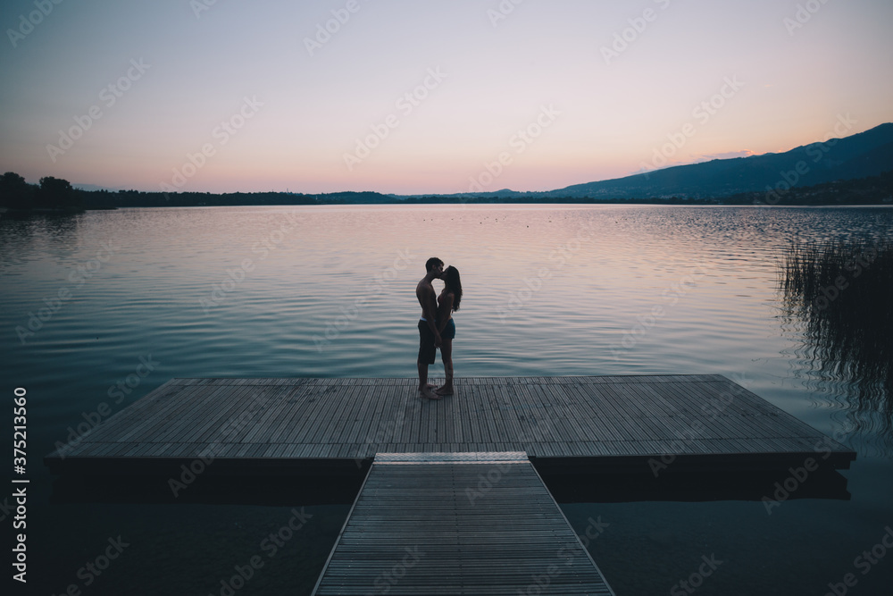 Couple kissing at sunset