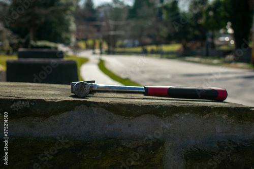 A Hammer With a Red and Black Handle on a Cobblestone Pillar © HRTNT Media