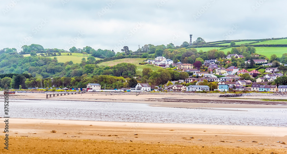A view from the village of Llansteffan, Wales across the river Towy towards the picturesque village of Ferryside in the summertime