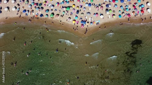 Beach with umbrellas in summer, drone shot