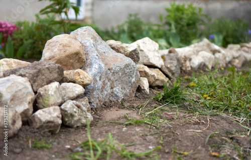 Wall of stones in a flower garden