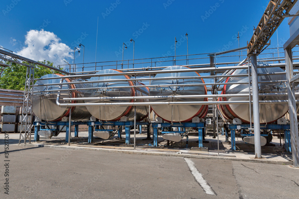 Naklejka premium Stainless steel reservoirs for wine at modern winery, Ukraine.