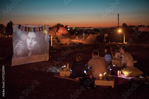 Friends Watching a Movie in Open Air Cinema