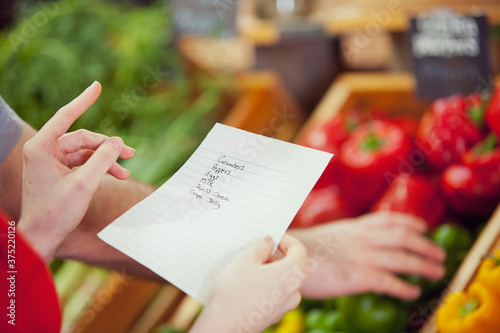 Market: Woman Holding Grocery List photo