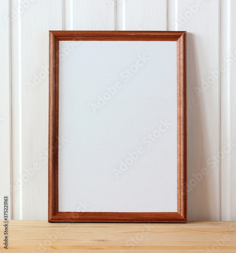 empty wooden frame on the table. mockup, scene creator.
