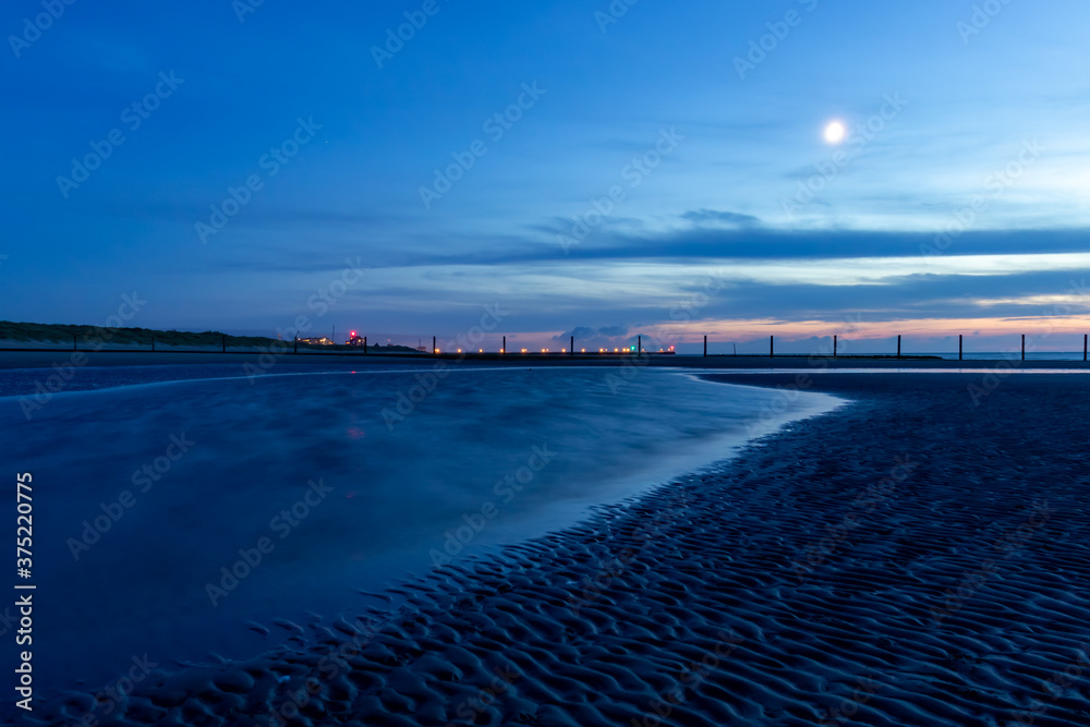 Blue hour on a beach on the Belgian coast on a summer night.