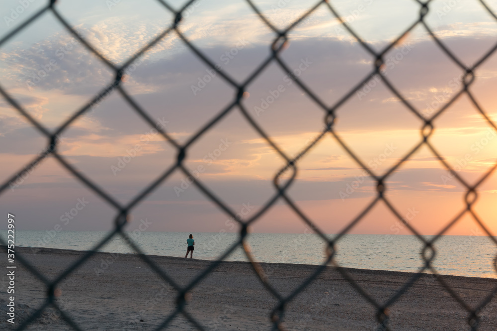 Lonely woman watching the dawn at sea.  Beautiful  seascape.