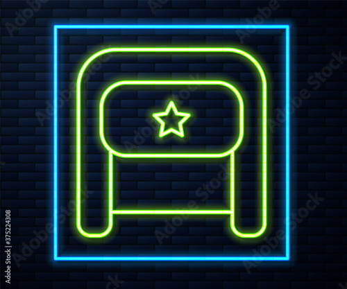 Glowing neon line Ushanka icon isolated on brick wall background. Russian fur winter hat ushanka with star. Soviet Union uniform of KGB and NKVD. Vector.