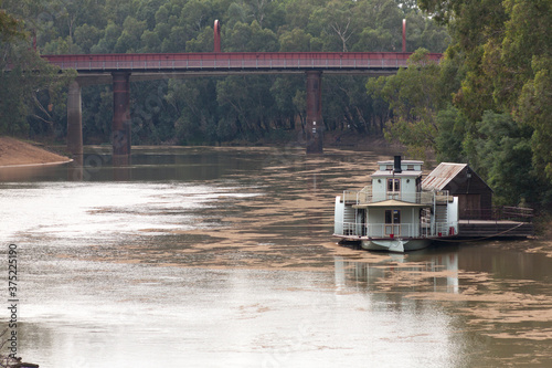 Historic paddle steamer with steel bridge photo