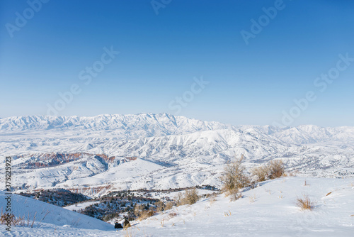 Picturesque Tien Shan mountains in Uzbekistan, covered with snow, winter clear Sunny day in the mountains