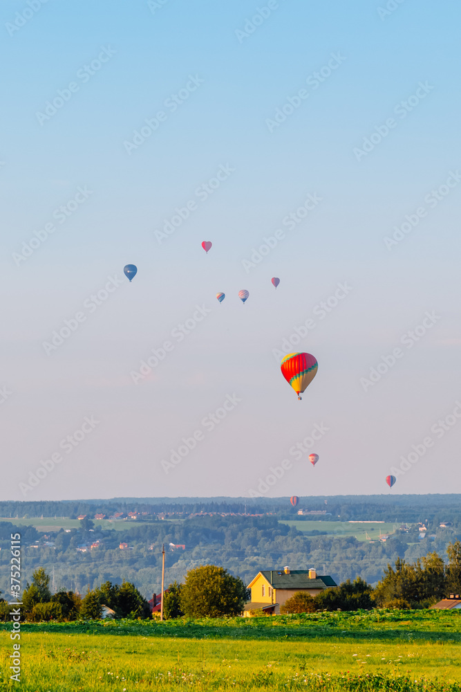 Fototapeta premium Hot air balloons over the countryside in summer