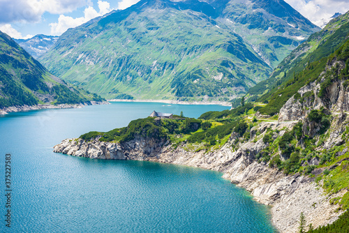 Blue lake called  K  lnbreinspeicher  at high elevation in the Austrian Alps