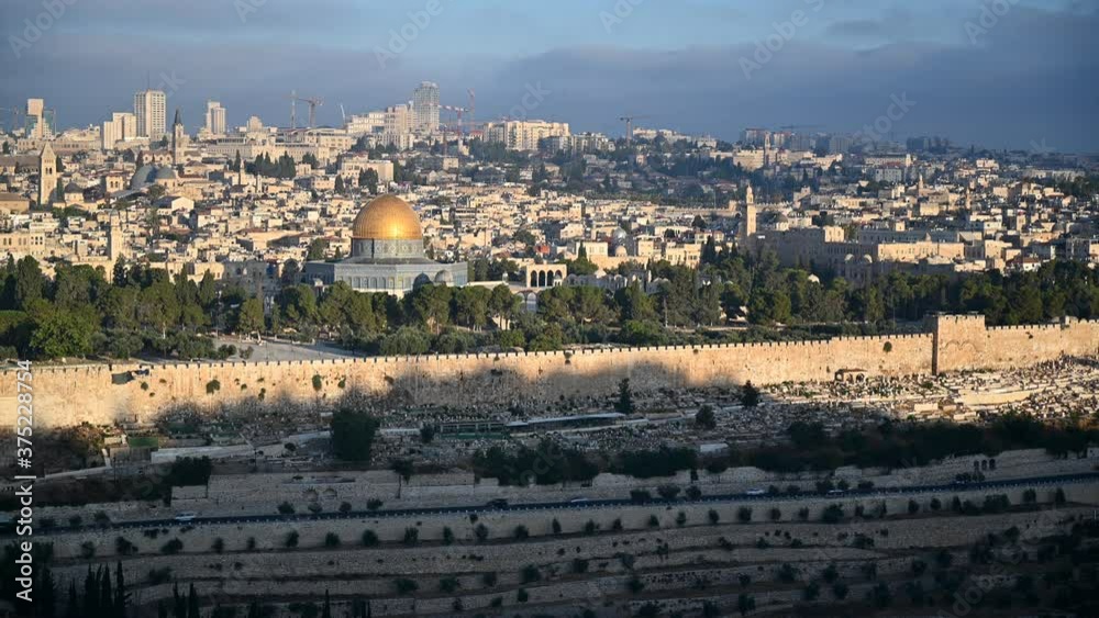 Morning sun hitting the City of Jerusalem: The Temple Mount with Dome of the Rock and the Golden Gate, the churches of the Old city, and West Jerusalem hotels and modern buildings in the background Morning sun hitting the City of Jerusalem: The Temple Mount with Dome of the Rock and the Golden Gate, the churches of the Old city, and West Jerusalem hotels and modern buildings in the background