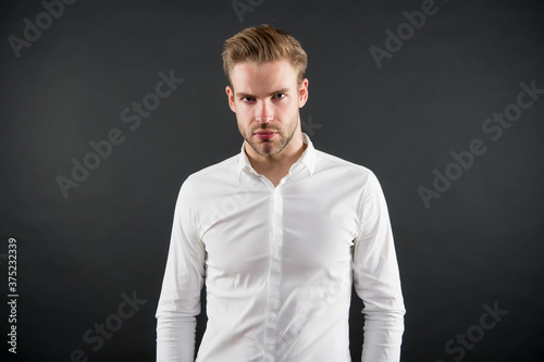 Handsome young man wear classy white shirt grey background, fashion
