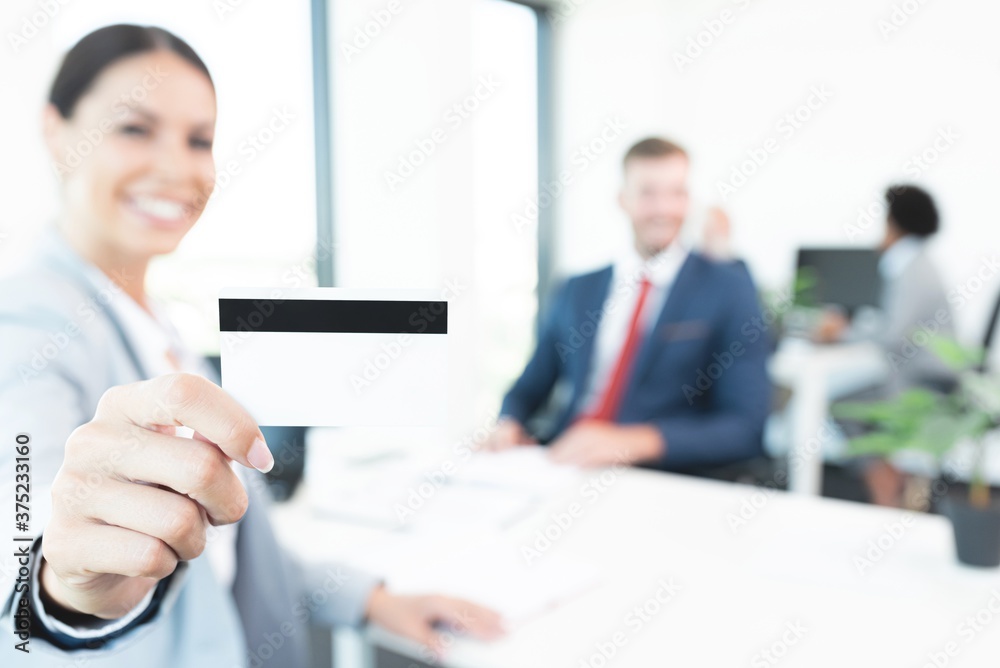 Businesswoman showing her credit card at bank Businesswoman showing her credit card at bank