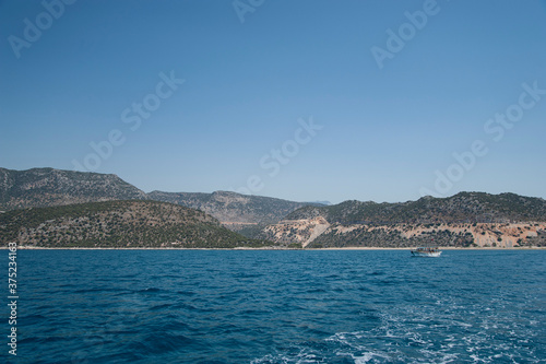 Beautiful sea rocky coast and yacht or boat. © viktor
