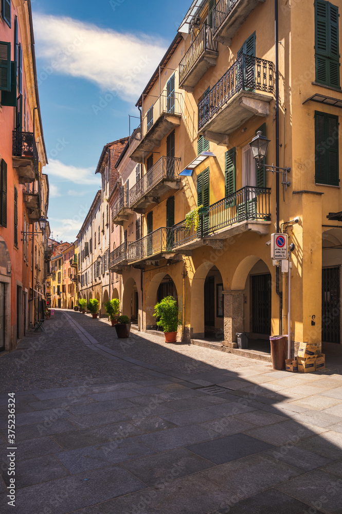 Typical colorful building on narrow cobblestone street in Mondovi, Cuneo, Piedmont