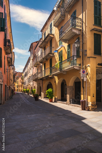 Typical colorful building on narrow cobblestone street in Mondovi, Cuneo, Piedmont