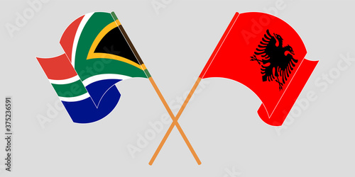 Crossed and waving flags of Albania and Republic of South Africa