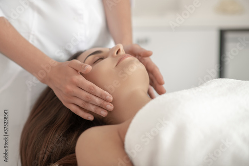 Professional doing face massage to a customer