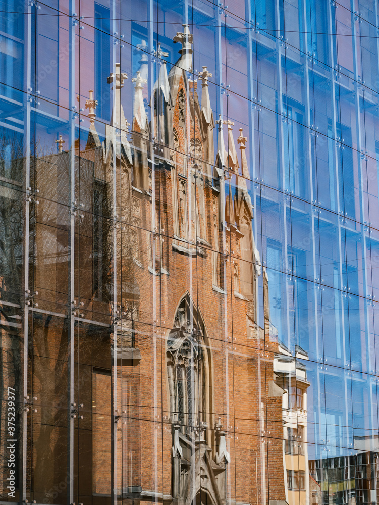 Facade of a church reflecting on glass wall