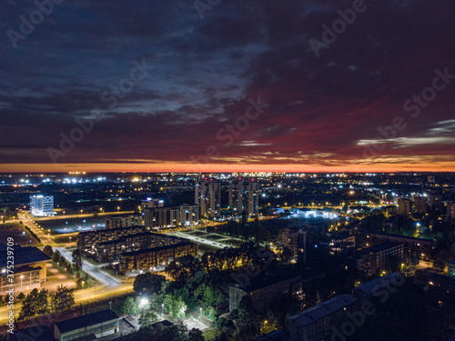 Midnight aerial view of Riga city skyline with crack of light on horizon