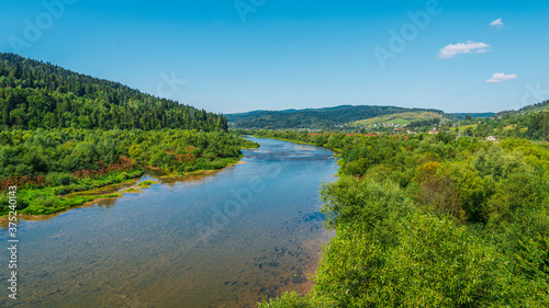 Summer landscape in the Carpathian mountains, the Stryi river in Rybnyk village.